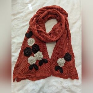 Orange crochet scarf with black cream flower appliques